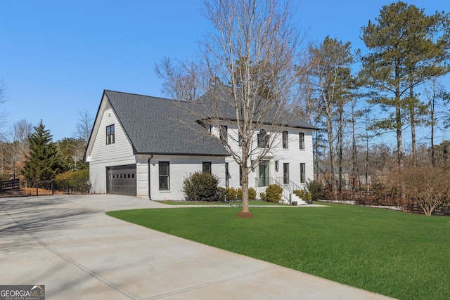 view of front of house with a garage and a front yard