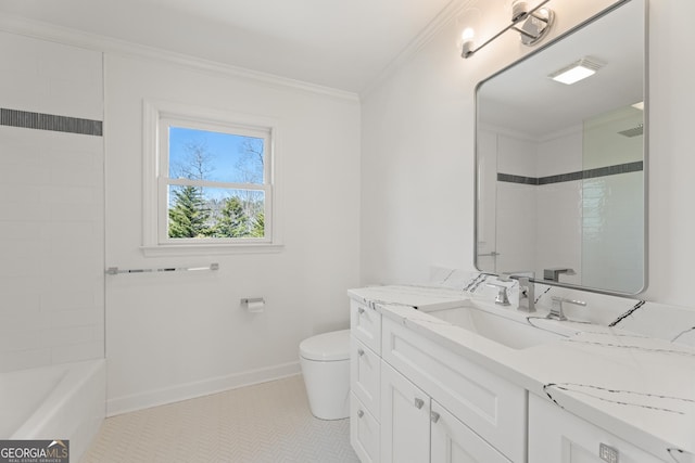 full bathroom featuring vanity, tiled shower / bath, ornamental molding, and toilet