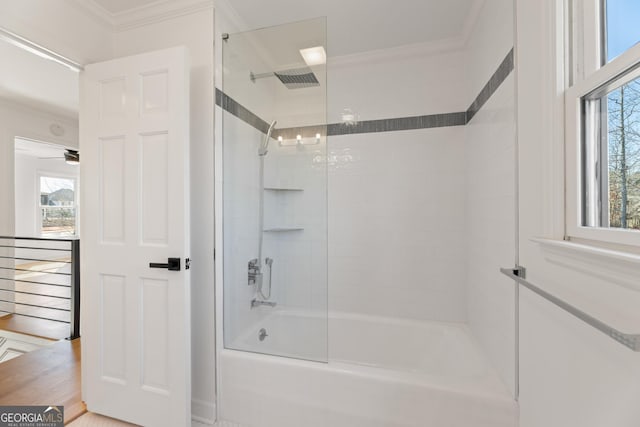 bathroom featuring tiled shower / bath combo and ornamental molding