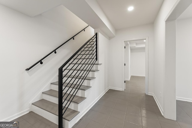 stairway featuring tile patterned flooring