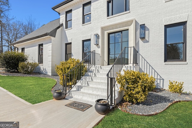 doorway to property featuring a yard