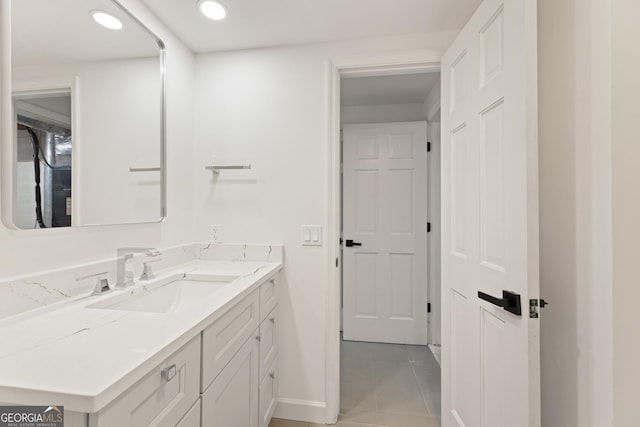 bathroom featuring tile patterned flooring and vanity