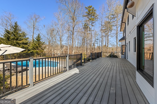 wooden terrace featuring a fenced in pool