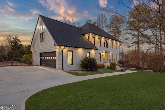 view of front facade featuring a garage and a lawn