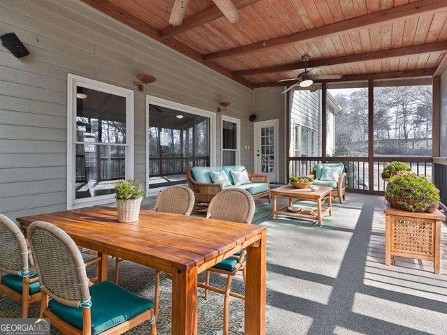 sunroom with wood ceiling, ceiling fan, and beam ceiling
