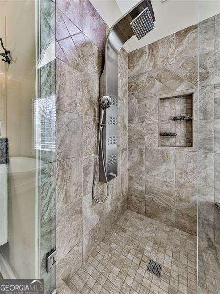bathroom with a shower with door