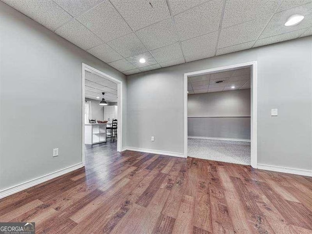 spare room featuring hardwood / wood-style floors and a paneled ceiling