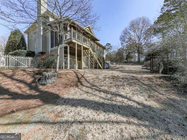 view of property exterior with a wooden deck