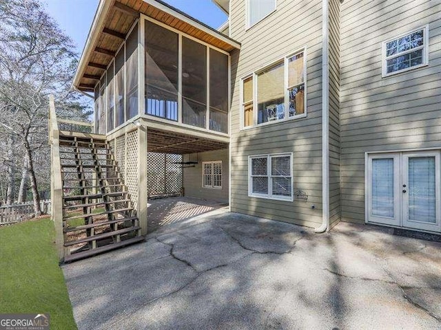 back of house featuring a patio area, a sunroom, and french doors