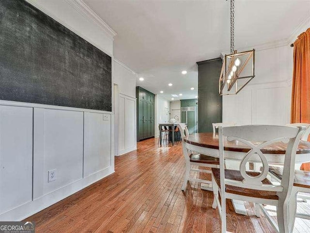 dining room featuring wood-type flooring and ornamental molding