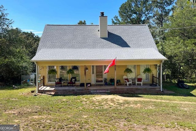 rear view of property with a yard