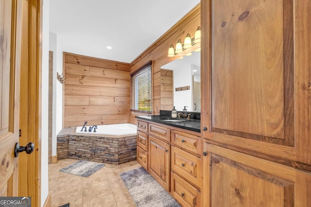 bathroom with vanity, wooden walls, tile patterned flooring, and tiled tub