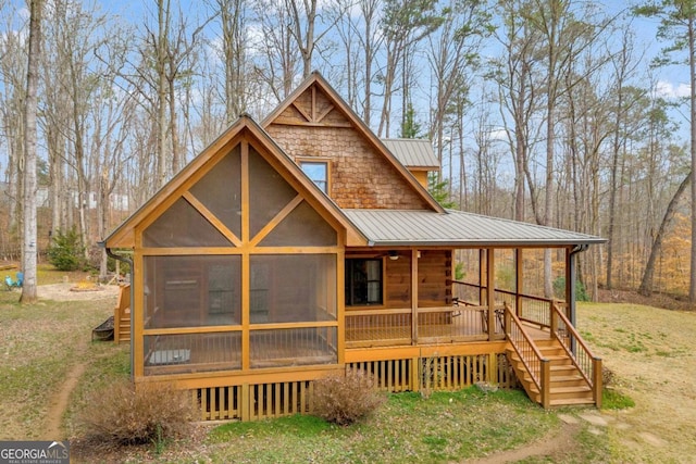 back of house with a sunroom