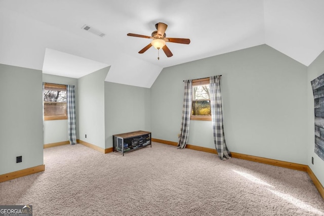 additional living space with lofted ceiling, carpet floors, and ceiling fan