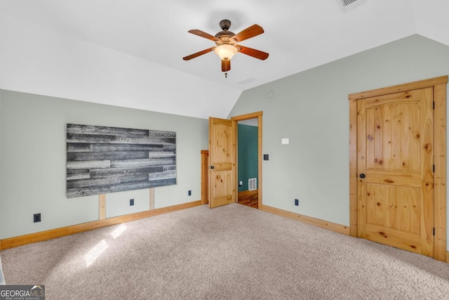 unfurnished bedroom with ceiling fan, carpet flooring, and vaulted ceiling