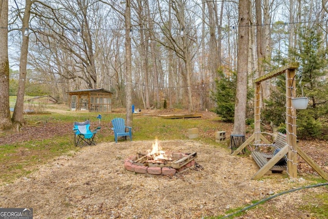 view of yard featuring an outdoor fire pit