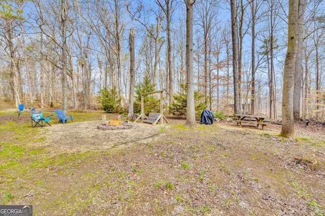 view of yard with a fire pit