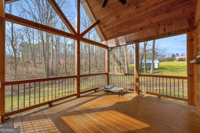 unfurnished sunroom featuring ceiling fan