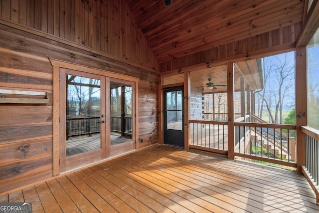 unfurnished sunroom with french doors, wooden ceiling, lofted ceiling, and a wealth of natural light