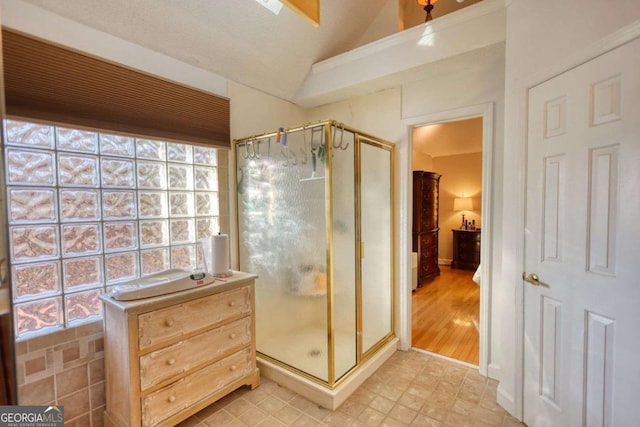 bathroom with lofted ceiling and walk in shower