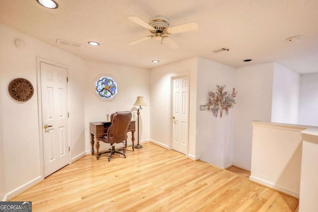 office with ceiling fan and light hardwood / wood-style flooring