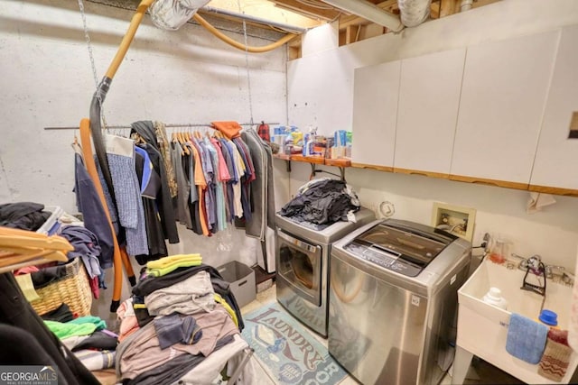 washroom with cabinets and separate washer and dryer