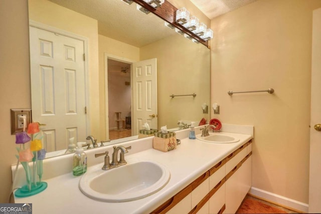 bathroom with vanity and a textured ceiling