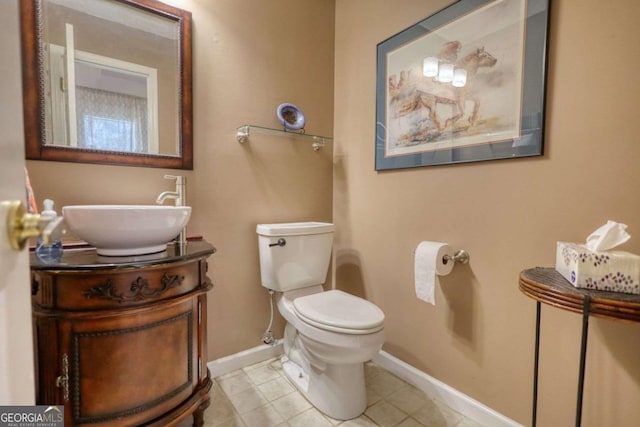 bathroom featuring vanity, tile patterned floors, and toilet