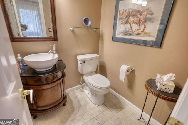 bathroom featuring tile patterned floors, vanity, and toilet