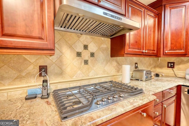 kitchen featuring tasteful backsplash, appliances with stainless steel finishes, and light stone countertops