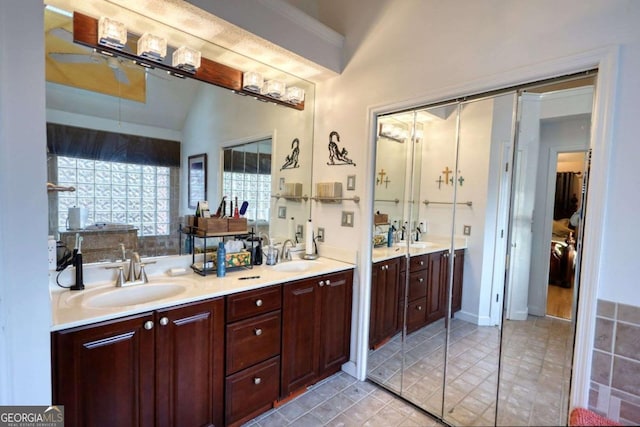 bathroom featuring vanity and lofted ceiling