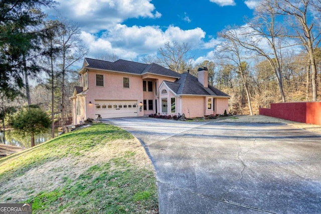 view of front of home featuring a garage and a front yard