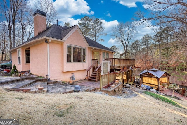 exterior space featuring a gazebo and a deck