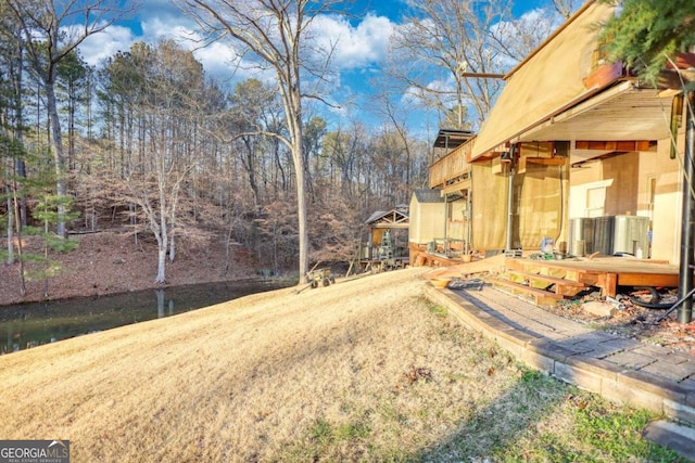 view of yard featuring a deck with water view