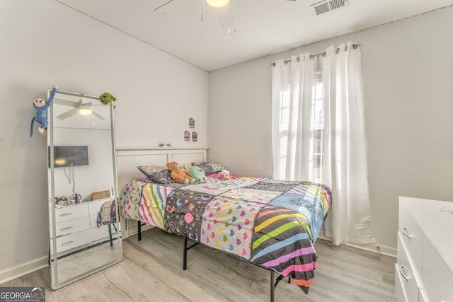 bedroom with ceiling fan and light hardwood / wood-style floors