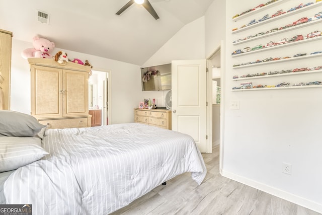 bedroom featuring ceiling fan, lofted ceiling, ensuite bathroom, and light hardwood / wood-style flooring