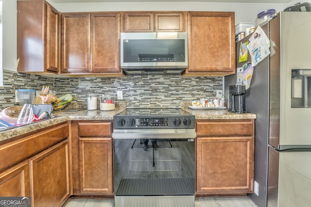 kitchen featuring decorative backsplash and stainless steel appliances