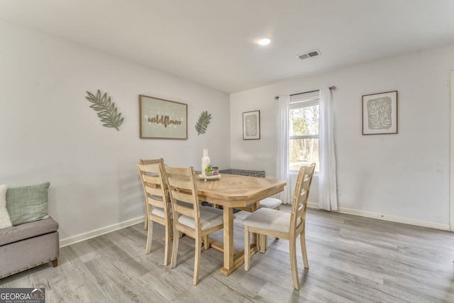 dining space with light wood-type flooring