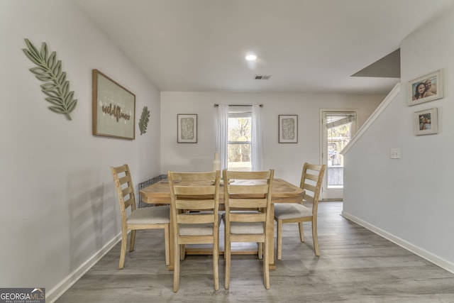 dining area featuring a healthy amount of sunlight and light hardwood / wood-style flooring