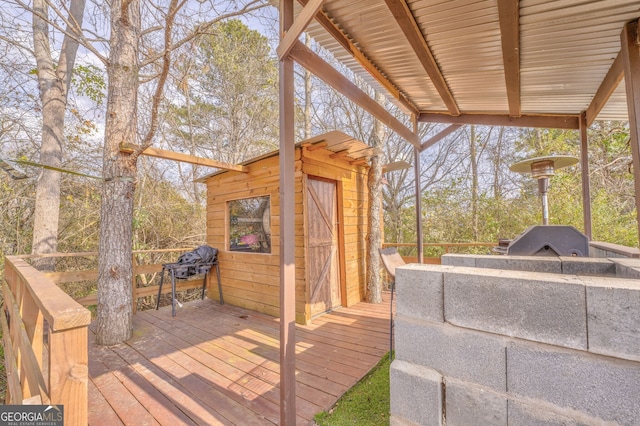 wooden deck featuring a grill