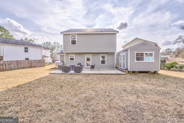 rear view of property with a storage unit, outdoor lounge area, a patio area, and a lawn