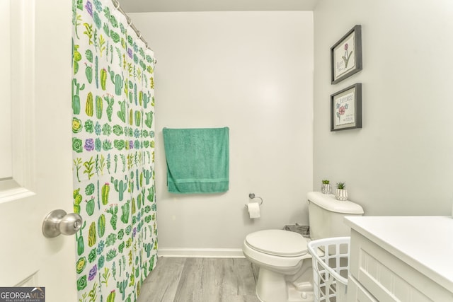 bathroom featuring hardwood / wood-style flooring, vanity, and toilet