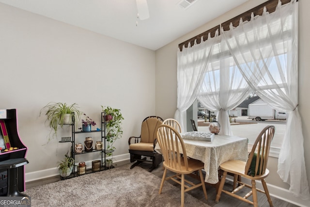 dining space with ceiling fan and hardwood / wood-style floors