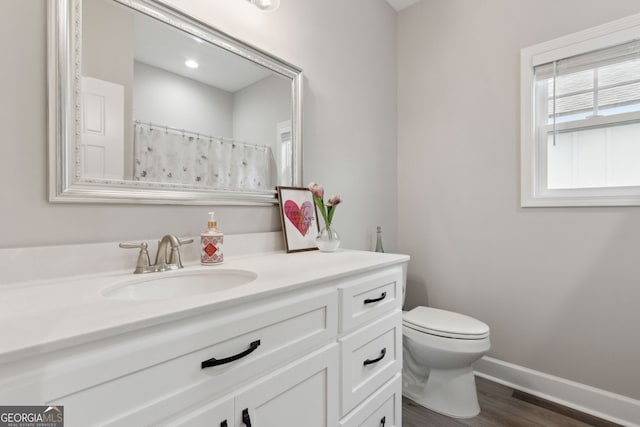 bathroom featuring a shower with curtain, vanity, hardwood / wood-style floors, and toilet