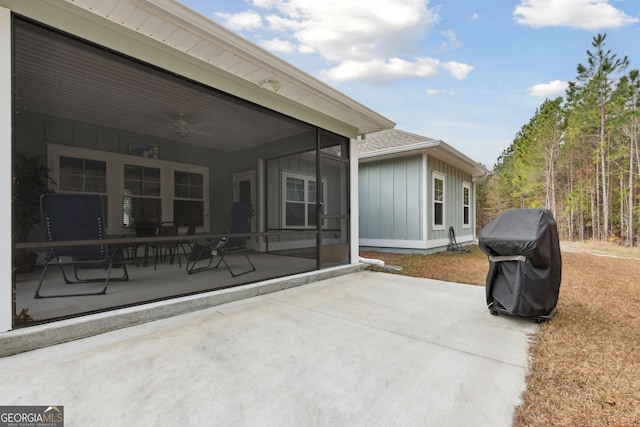 view of patio with grilling area, a sunroom, and ceiling fan