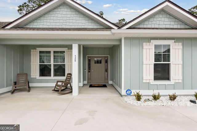 view of exterior entry with a porch