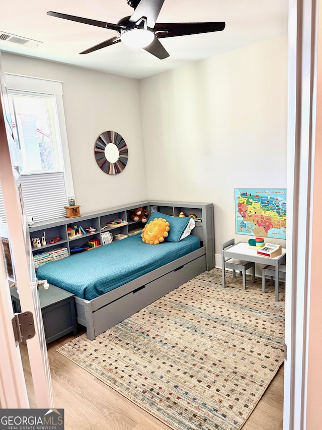 bedroom featuring light hardwood / wood-style flooring and ceiling fan