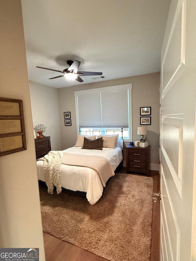 bedroom featuring hardwood / wood-style flooring and ceiling fan