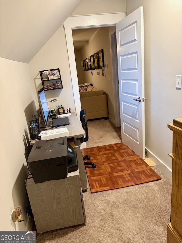 carpeted office with vaulted ceiling