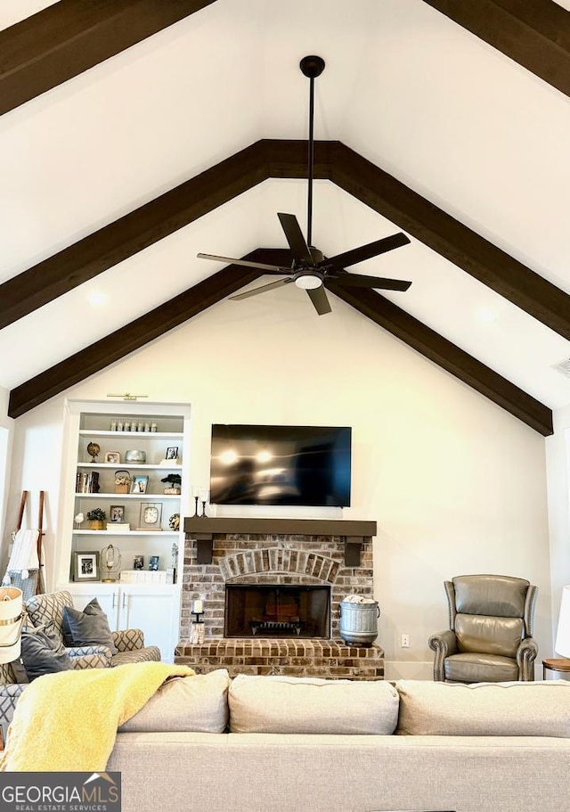 living room with ceiling fan, a fireplace, and lofted ceiling with beams